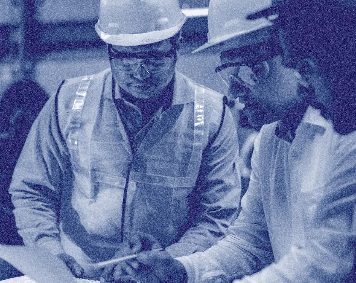 Two engineers reviewing an infrastructure plan on site